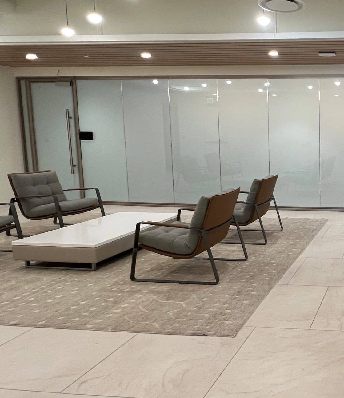 Modern office reception area with electronic window tint for office privacy, showcasing conference room smart glass privacy and switchable glass film installation.